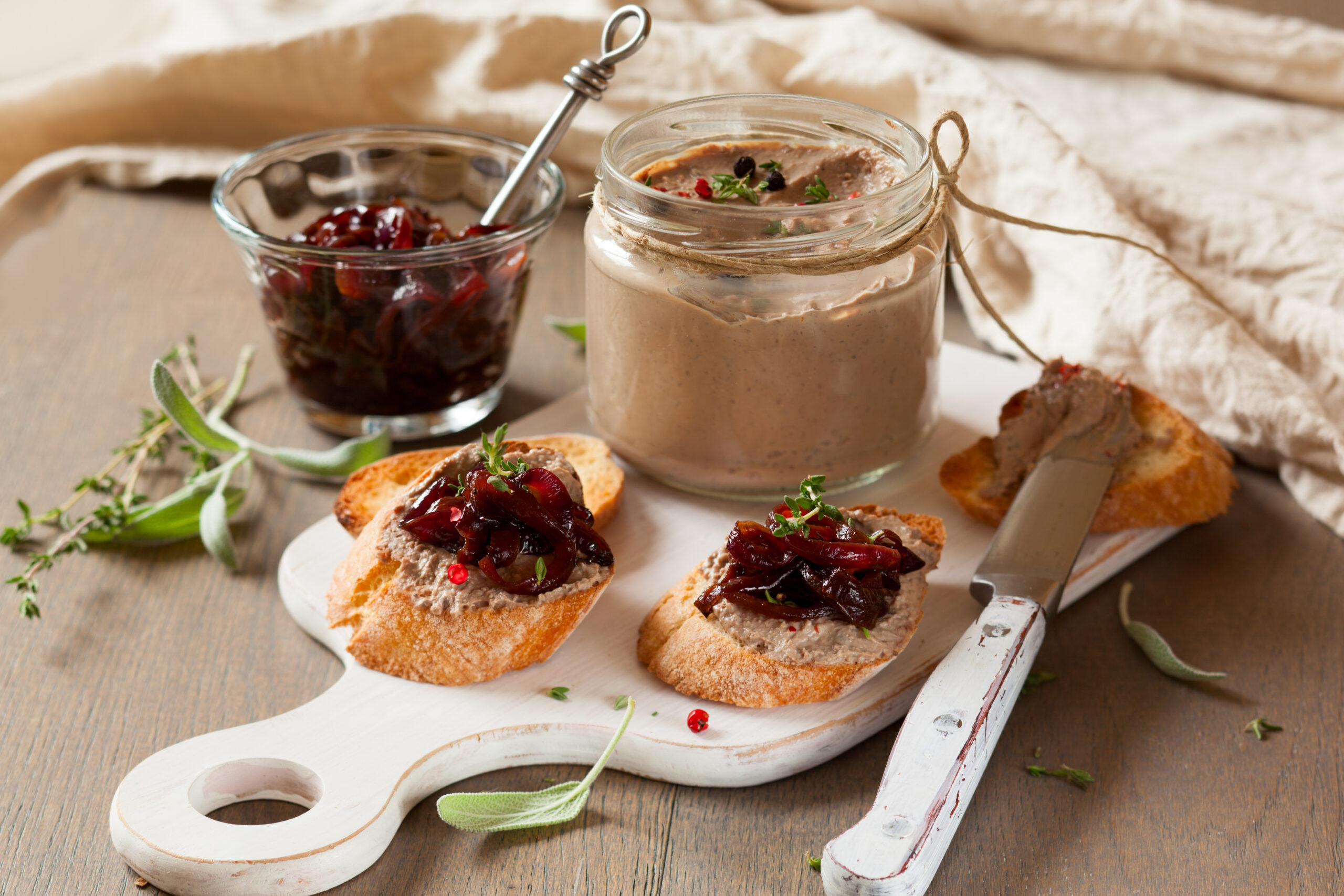 Chicken liver pate with onion jam on bread and in jar
