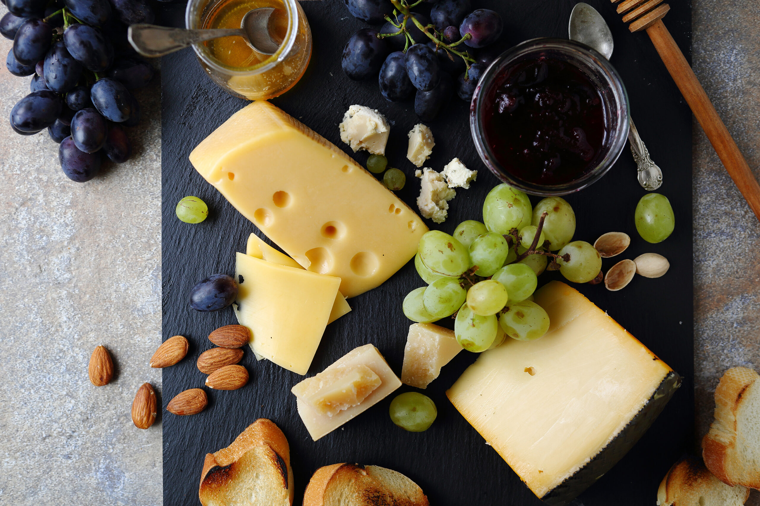 delicatessen cheeses with grapes, food top view